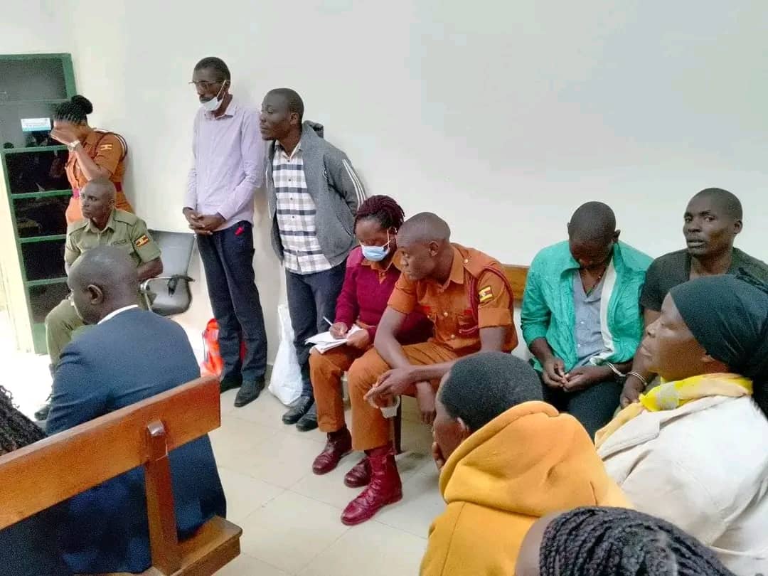 Courtesy photo of Dickson Mubiru and Alirabaki Sengooba standing in between Prison officers at Makindye Court.