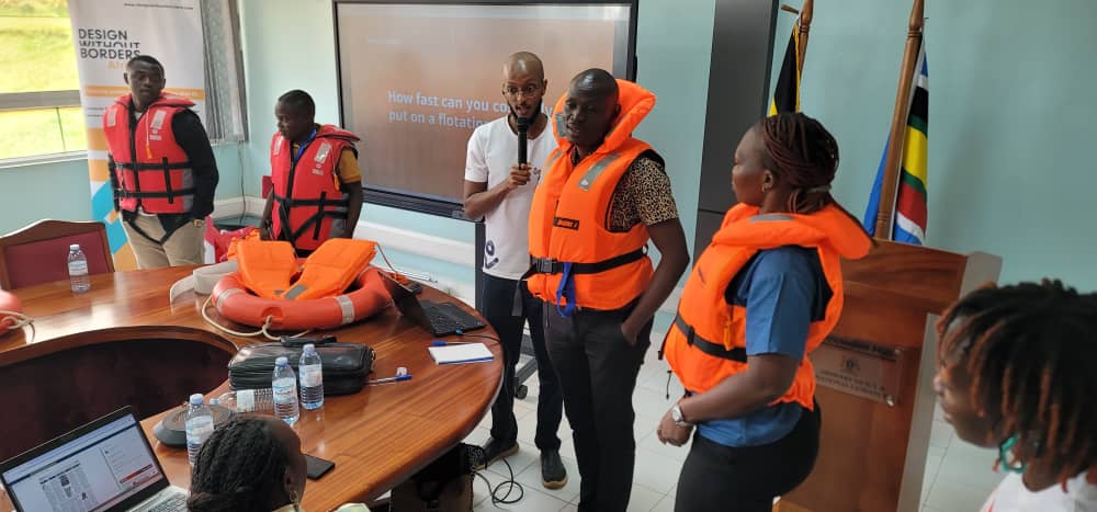 A section of journalists demonstrating how original life jackets operate defer from the fake; February 20, 2026. Phpto by Mukose Arnold Anthony.